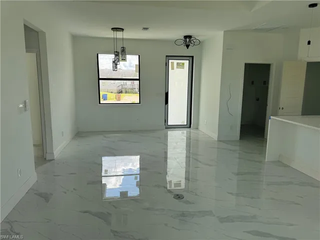 Spare room featuring light marble finish floors
