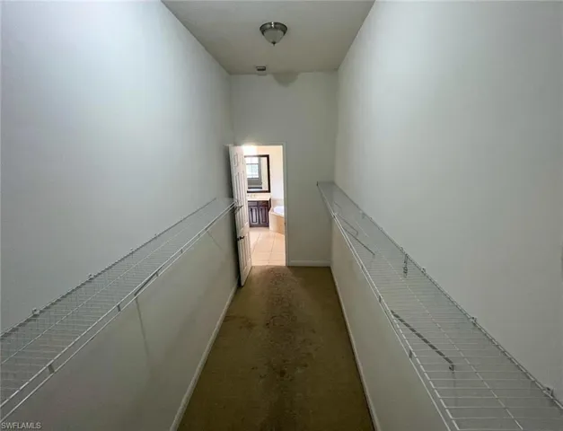 Hall featuring carpet flooring