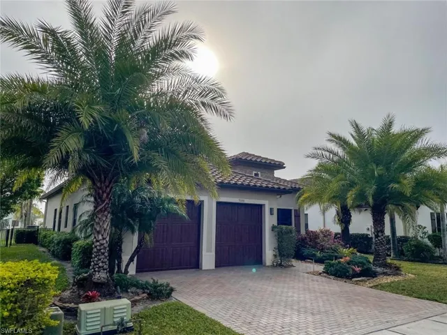 Mediterranean / spanish home featuring a garage