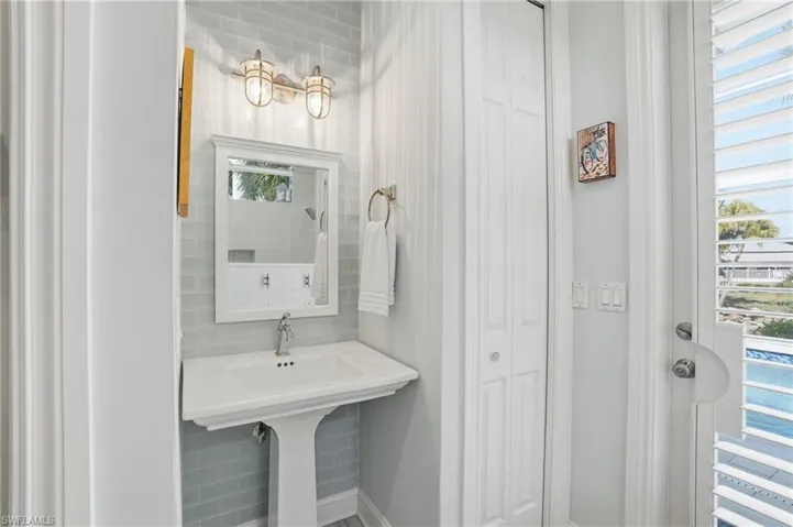 Bathroom with a closet and baseboards