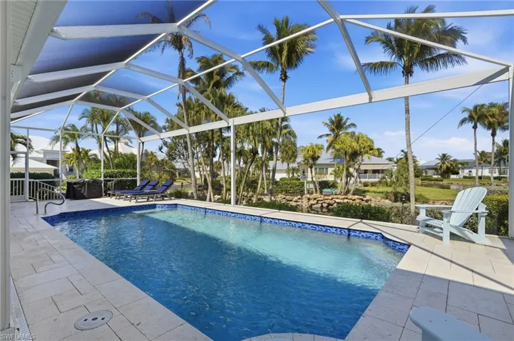 Outdoor pool featuring a patio area, a lanai, and a sunroom