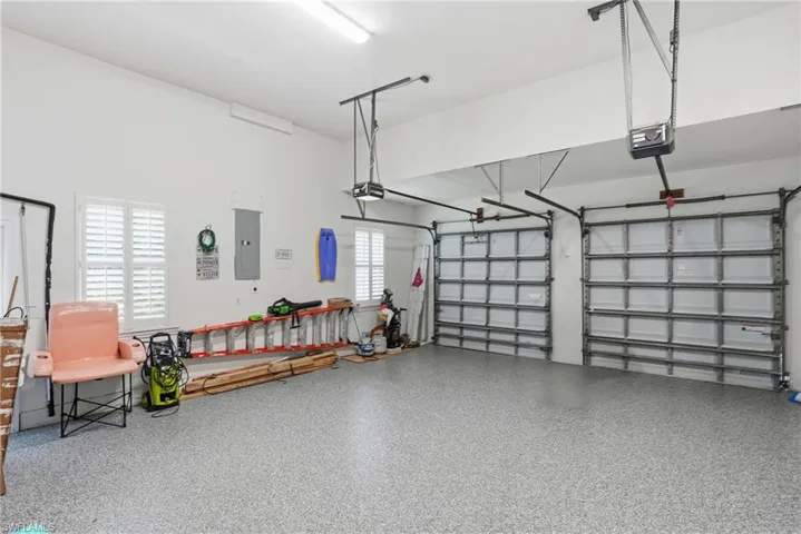 Garage with electric panel and a garage door opener