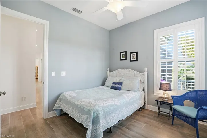 Bedroom featuring wood finish floors and ceiling fan
