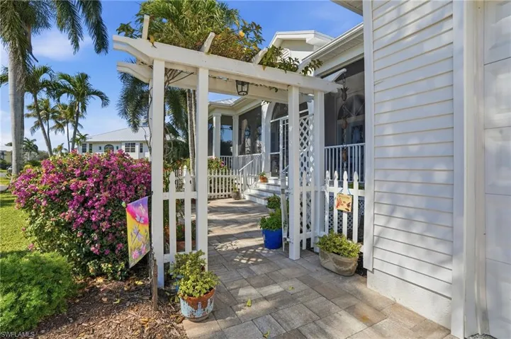 View of patio with a sunroom