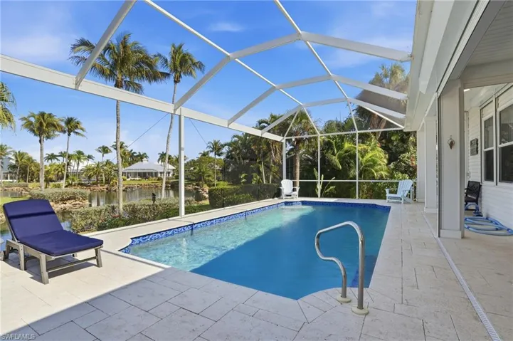Swimming pool featuring a patio, a sunroom, a lanai, and a water view
