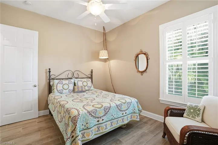 Bedroom featuring wood finish floors and ceiling fan