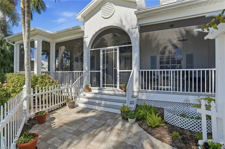 Doorway to property featuring a sunroom and a patio area