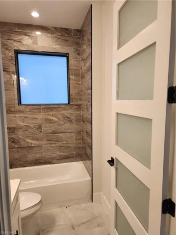 Bathroom featuring vanity and bathing tub / shower combination