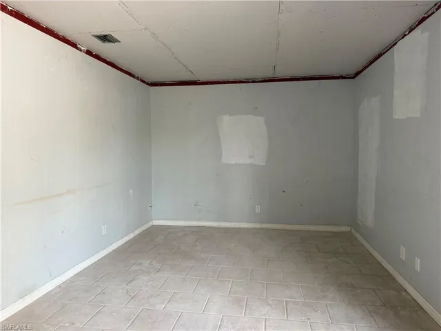 Spare room featuring baseboards