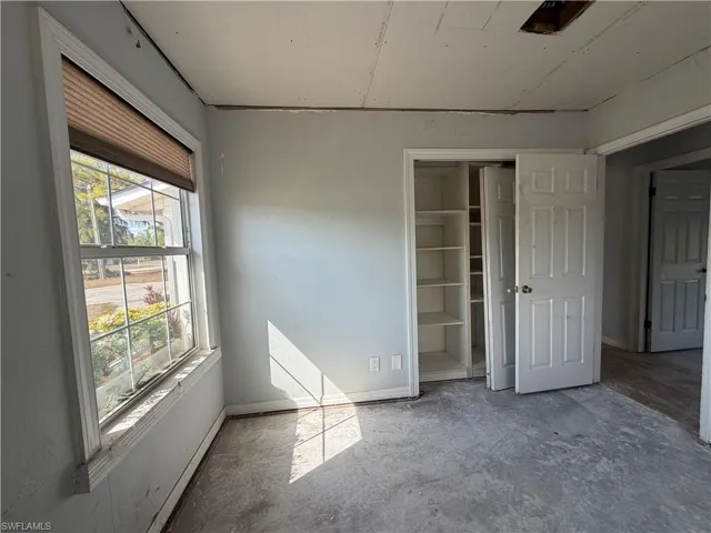 Unfurnished bedroom with baseboards and a closet