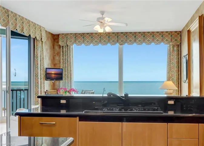 Kitchen featuring ceiling fan and a wealth of natural light