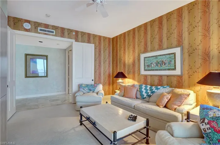 Living room featuring light carpet and ceiling fan