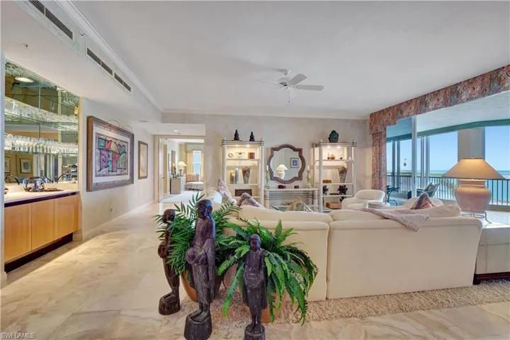 Living room with ceiling fan and ornamental molding
