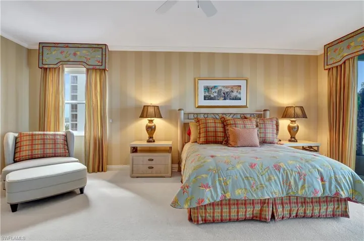 Bedroom featuring ceiling fan, carpet, and crown molding