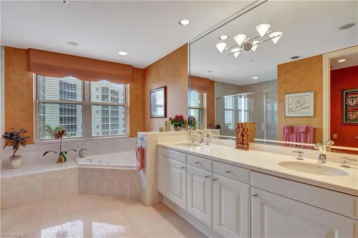 Bathroom with tile patterned floors, vanity, and plus walk in shower