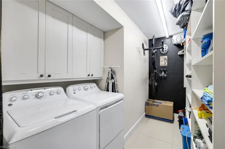 Laundry room with upper cabinet space and storage racks