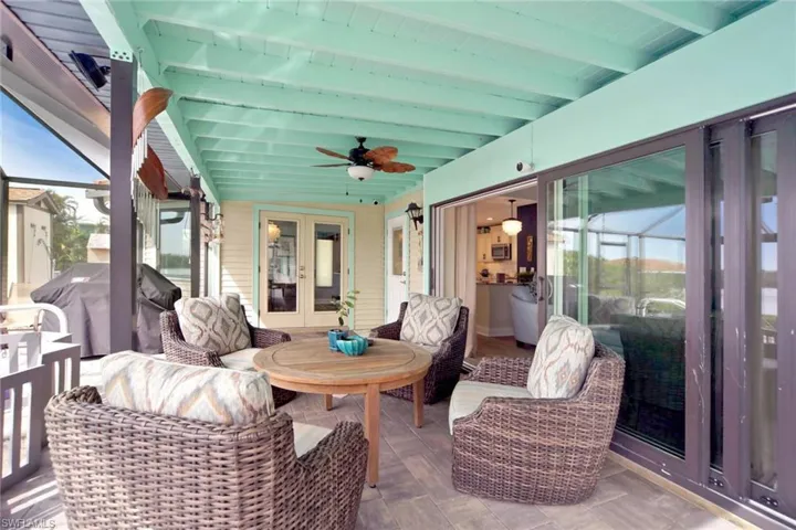french doors, ceiling fan, and beam ceiling