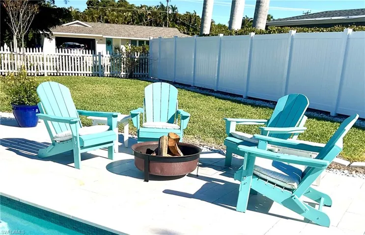 Fenced backyard featuring a fire pit and a patio