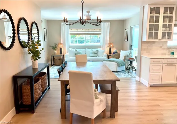 Dining area featuring light wood-style flooring and a chandelier