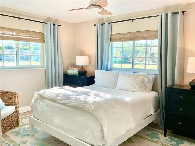Bedroom with ceiling fan and multiple windows