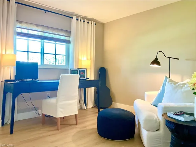 Office with wood finished floors and baseboards