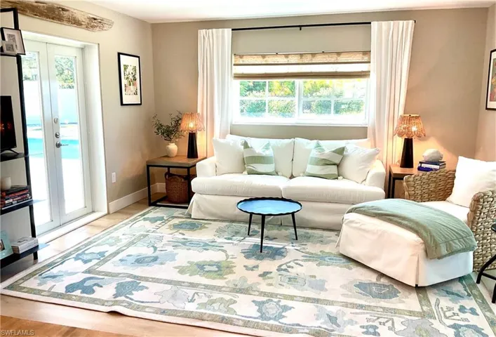 Living room featuring light wood-style floors and french doors