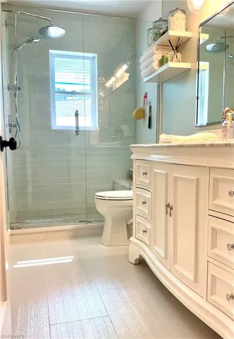 Bathroom with vanity and a shower stall