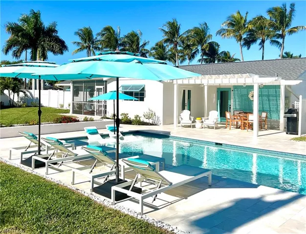 Swimming pool with a patio, a grill, a pergola, and outdoor dining area