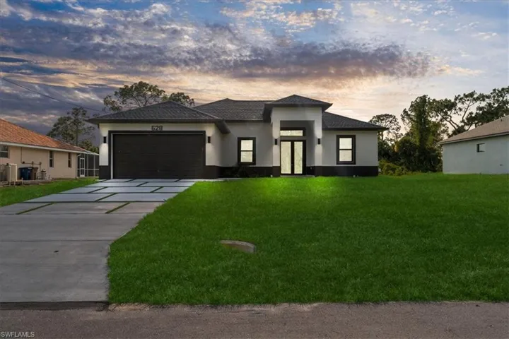 Contemporary single-story residence featuring a two-tone exterior, a dark-toned asphalt shingle roof, and a prominent two-car garage
