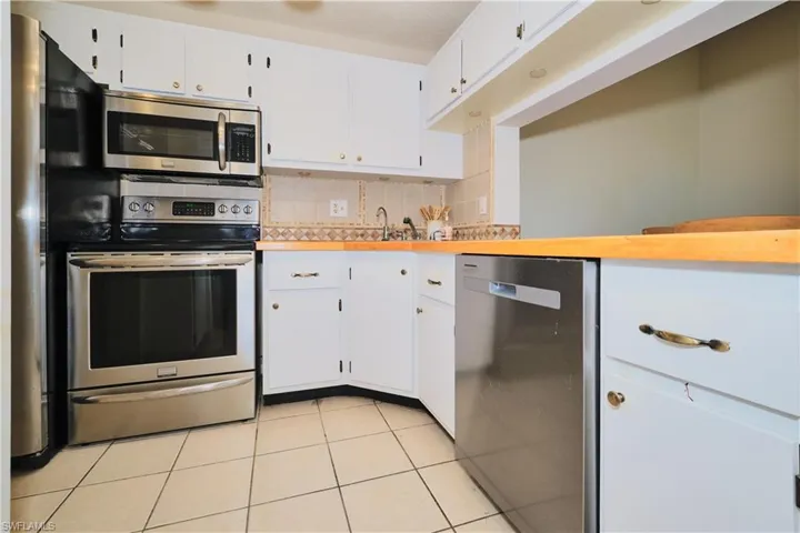 Kitchen features stainless steel appliances with new dishwasher.