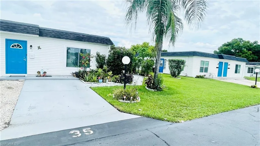 Ranch-style home featuring a front lawn