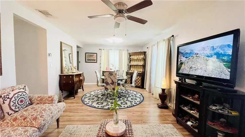 Living room featuring ceiling fan and hardwood / wood-style floors