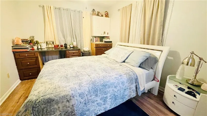 Bedroom with wood-type flooring