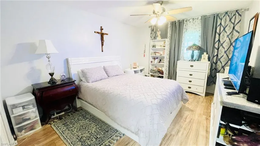 Bedroom featuring light wood-type flooring and ceiling fan