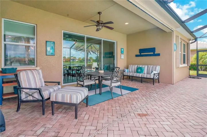 View of patio with ceiling fan, an outdoor hangout area, and a lanai