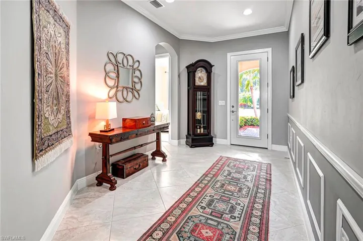 Foyer featuring ornamental molding