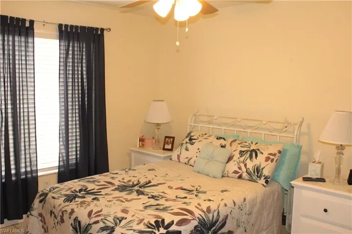 Bedroom featuring multiple windows and ceiling fan