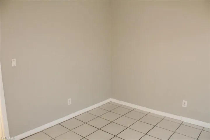 Spare room featuring baseboards