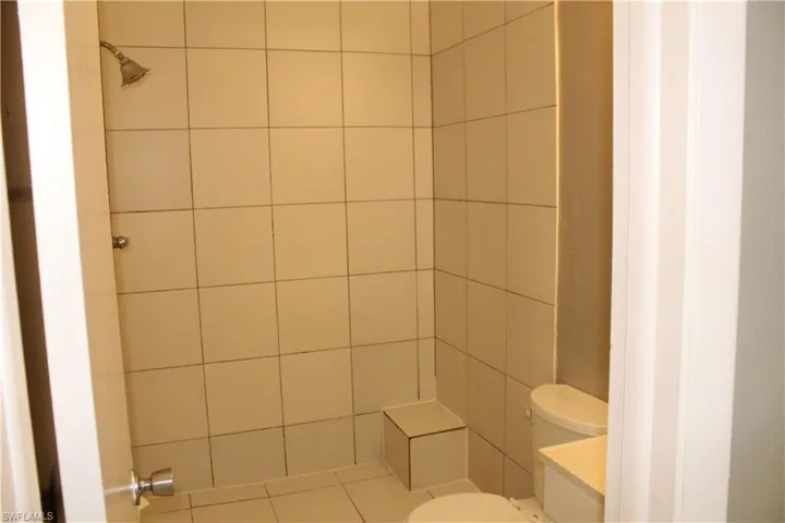 Full bathroom featuring toilet and a shower