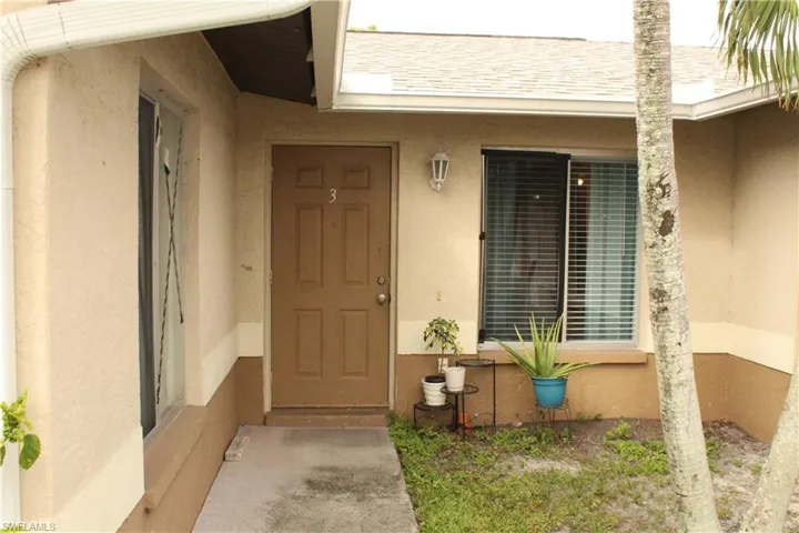Doorway to property with stucco siding