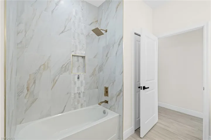 Bathroom featuring Italian Tile flooring and tiled shower / bath