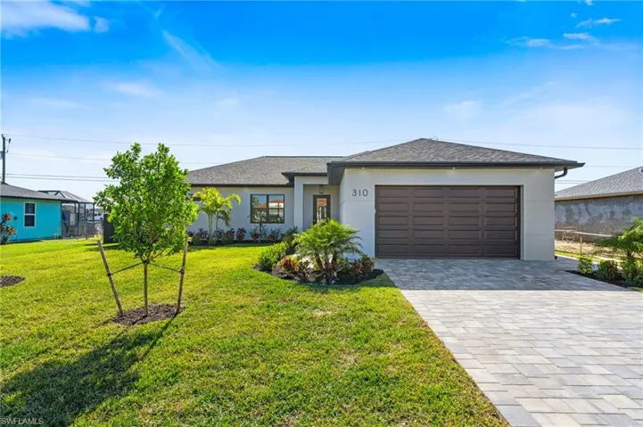 View of front of house featuring lush landscaping