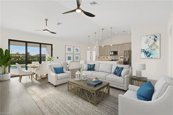 Living room featuring ceiling fan and vaulted ceiling, virtually staged
