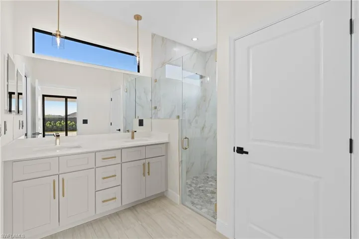 Bathroom with Italian tile flooring, vanity, and a shower with shower door
