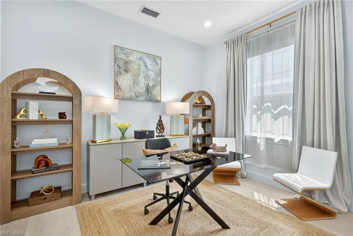 Home office with light wood-type flooring and recessed lighting
