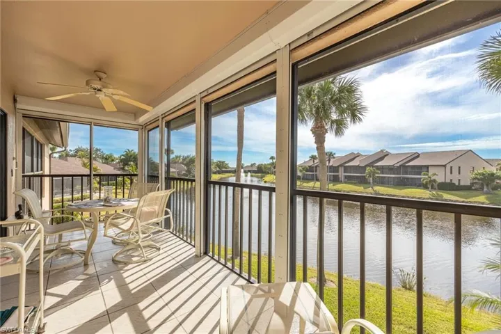 Sunroom / solarium with a water view and ceiling fan