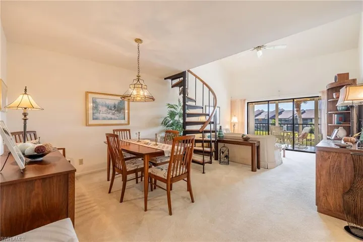 Dining space featuring ceiling fan and light carpet