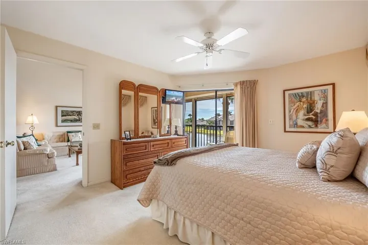 Bedroom featuring ceiling fan, light carpet, and access to outside