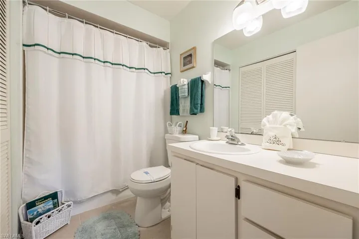 Bathroom with tile patterned floors, vanity, and toilet