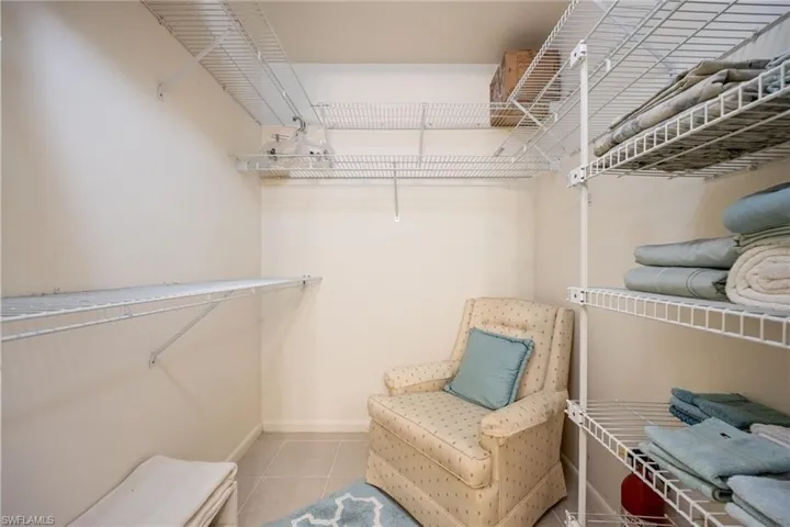 Spacious closet with light tile patterned floors